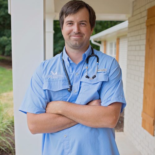 Dr Rob standing outside clinic with stethoscope in Woodstock GA